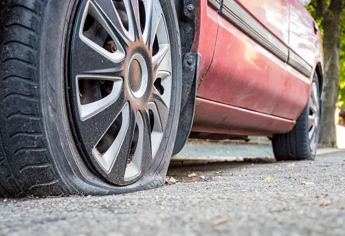 Stranded car with a flat tyre