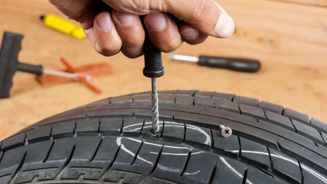 Mechanic repairing a punctured tyre