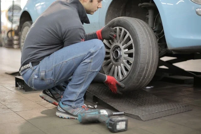 Mobile tyre technician performing 24/7 emergency workers on location in London