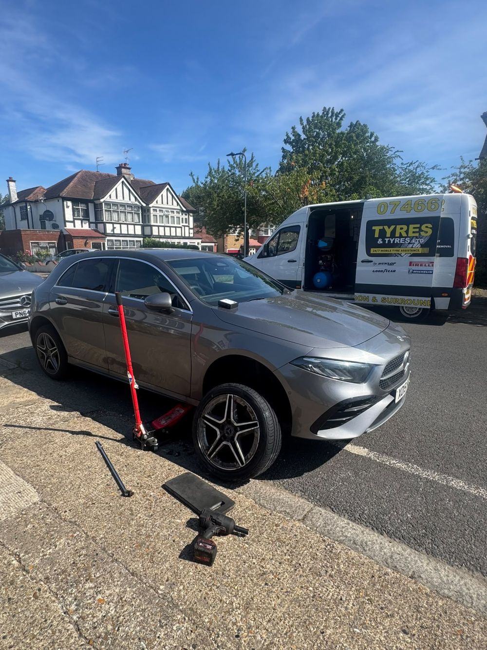 Mobile tyre technician performing 24/7 emergency tyre fitting on location in London